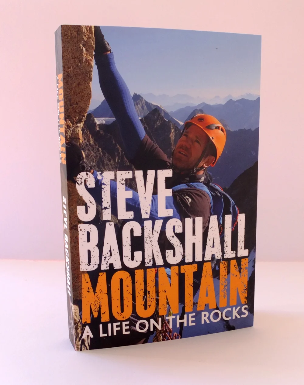 Paperback of Steve Backshall's Mountain: A Life on the Rocks, with a photograph of Backshall climbing in an orange helmet